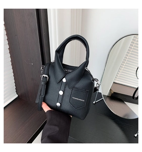 Detail of creative shirt-shaped black leather handbag with silver buttons and pocket