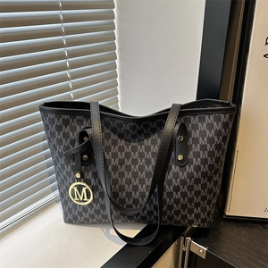 Large grey monogram tote bag with leather straps and gold metal 'M' charm detail