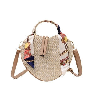 Handmade heart-shaped woven straw bag with floral silk scarf handle and leather strap
