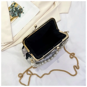 Detail of floral shell bag showing internal compartment, gold chain and pearl handle