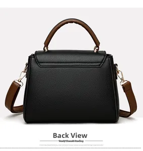 Rear view of black lychee grain leather tote bag with brown straps and gold metal buckles