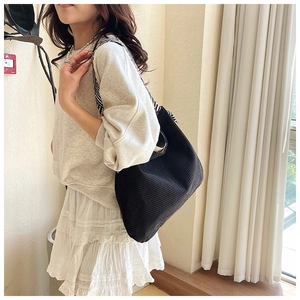 Detail of black canvas tote bag with a geometric herringbone pattern wide shoulder strap
