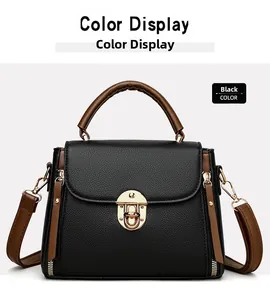 Close-up of black leather handbag with brown handles and elegant metal rotating lock