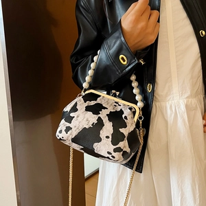 Retro cow print shell bag with pearl chain handle and gold metal clasp for women