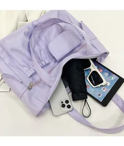 Detailed interior of purple nylon tote showing capacity for tablet, umbrella, and sunglasses