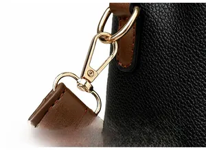 Detail of high-quality gold plating lobster clasp on black lychee grain leather bag