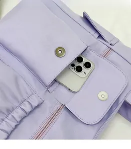 Detail of purple tote bag showing magnetic flap pocket and zipper compartment storage