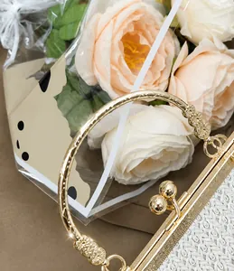 Detail of vintage shell bag showing woven texture, gold metal ring handle and ball clasp