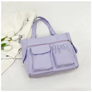 Detail view of lavender multi-pocket tote bag showing texture and storage compartments