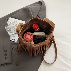 Bohemian brown tassel crossbody bag showing large capacity for umbrella and phone