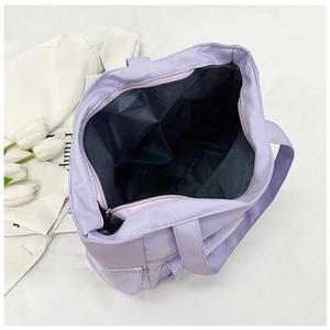 Top view of purple nylon tote bag interior with zipper and organized compartments