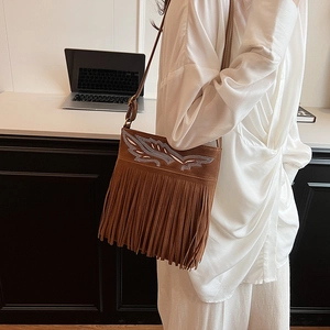 Bohemian brown suede shoulder bag with rhinestone wings and long fringe tassels