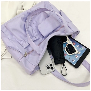 Top view of large purple tote bag interior showing storage for tablet and umbrella