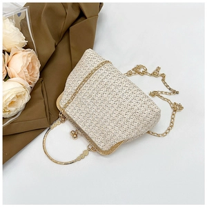 Detailed shot of retro straw woven handbag featuring vintage gold clasp and ring handle
