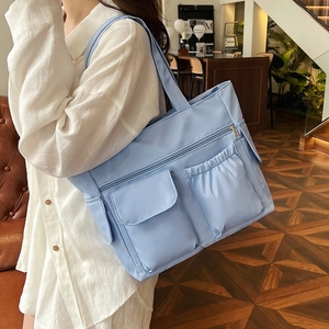 Minimalist light blue large capacity tote bag with multi-pockets and shoulder strap