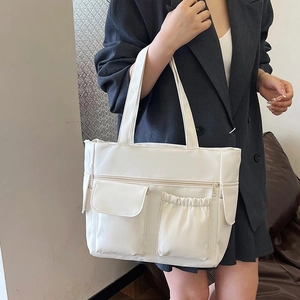 Minimalist large capacity white tote bag with multi-pockets shown on model
