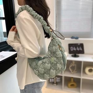 Light green quilted puff shoulder bag with ruffled strap and stylish bubble texture