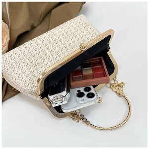 Top view of woven straw shell bag showing spacious interior with golden metal frame