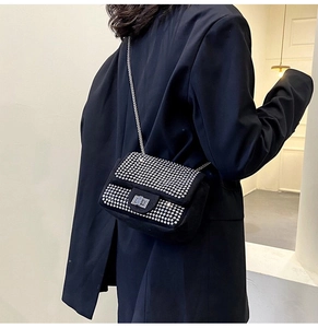 Dettaglio della borsa a tracolla in velluto nero con strass argento e catena in metallo