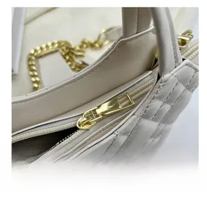 Close-up of quilted cream leather texture and premium smooth gold zipper detail