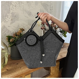 Close-up of black rhinestone tote bag with sparkling crystal mesh and matching coin purse