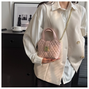 Pink quilted mini crossbody bag with gold chain strap and metal lock detail