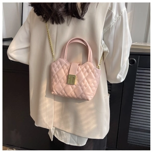 Pink quilted crossbody bag with gold chain strap and square metal turn-lock detail