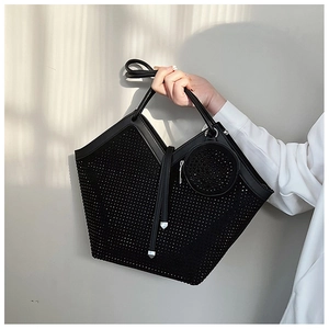 Close-up of black rhinestone tote bag with unique V-cut design and round coin purse detail