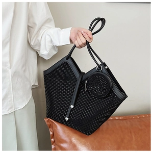 Detail of black tote bag with silver rhinestones and matching round coin purse pendant