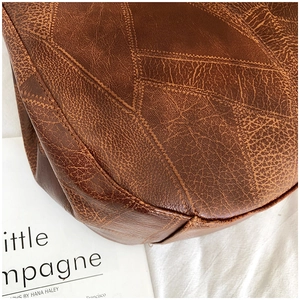 Detailed close-up showing the soft lychee texture and stitching of this brown leather tote