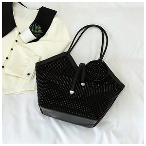 Detail of black rhinestone tote bag showing shiny texture and circular coin pouch