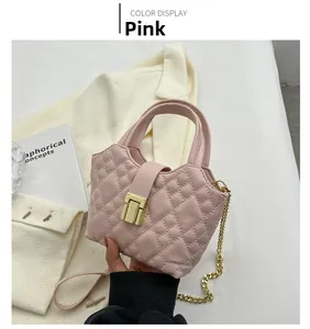 Close-up of pink quilted mini bucket bag with gold clasp and chain strap detail