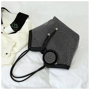 Close-up of black rhinestone tote bag with sparkling studs and small round coin purse charm