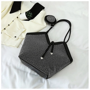 Detail of black tote bag featuring shimmering silver rhinestones and a mini round pouch