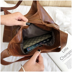 Internal view of brown crocodile texture tote bag showing large capacity and zipper pocket