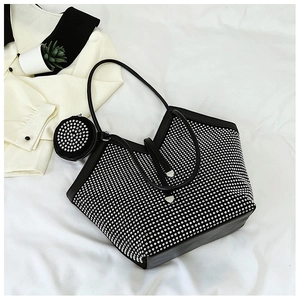 Detail of a large black rhinestone tote bag with a matching small round hanging coin purse