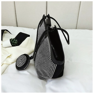 Close-up of rhinestone tote bag with black leather trim and matching round coin purse