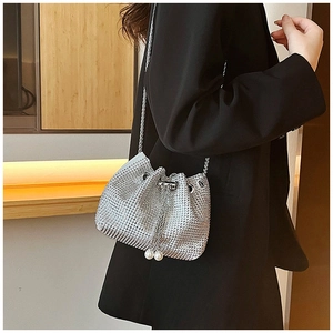 Détail du sac seau en strass argenté avec chaîne en métal et breloques de perles