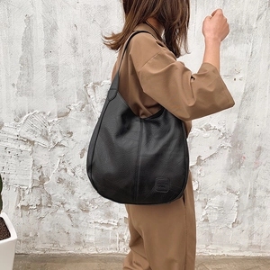 Retro black soft leather tote bag for women featuring a spacious minimalist hobo design