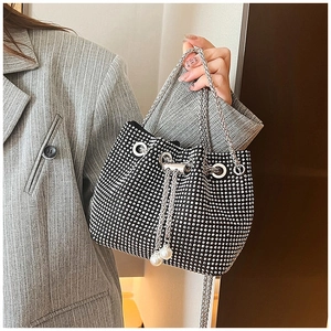 Détail du sac seau en strass avec cordon de perles et bandoulière en chaîne argentée