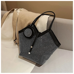 Detail of black tote bag with silver rhinestones and matching round coin purse on sofa