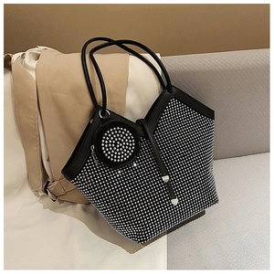 Detail of a black rhinestone tote bag featuring a matching round coin purse charm