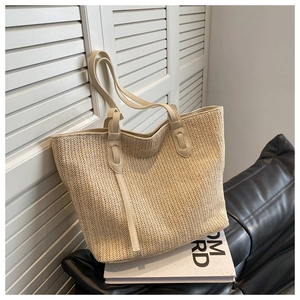 Vue détaillée du tissage beige et de la bandoulière en cuir crème de ce sac fourre-tout