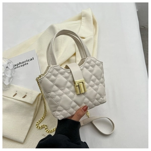 Detail of beige quilted mini bucket bag with gold chain strap and metal clasp lock