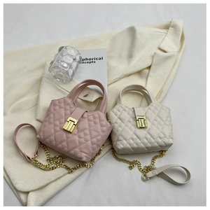 Detail of pink and white quilted handbags with gold square locks and chain straps
