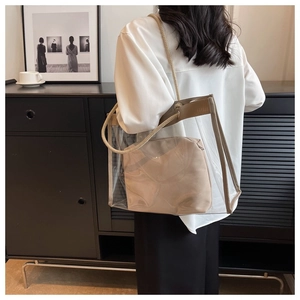 Detailed shot of transparent PVC tote bag with beige inner pouch and rope shoulder straps