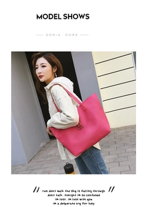 Model show of a large rose red pebble leather tote bag with stylish metal buckle detail