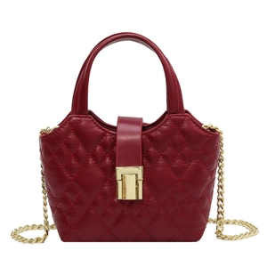 Mini red quilted leather handbag with gold metal clasp and elegant chain shoulder strap