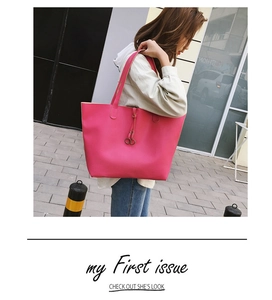 Detail of fuchsia leather tote bag with metallic ring charms and large capacity structure