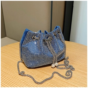 Détail du sac seau en strass bleu avec chaîne argentée et cordons ornés de perles
